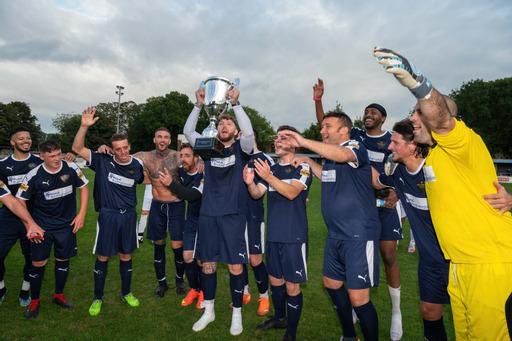Amateur Footballers raising trophy