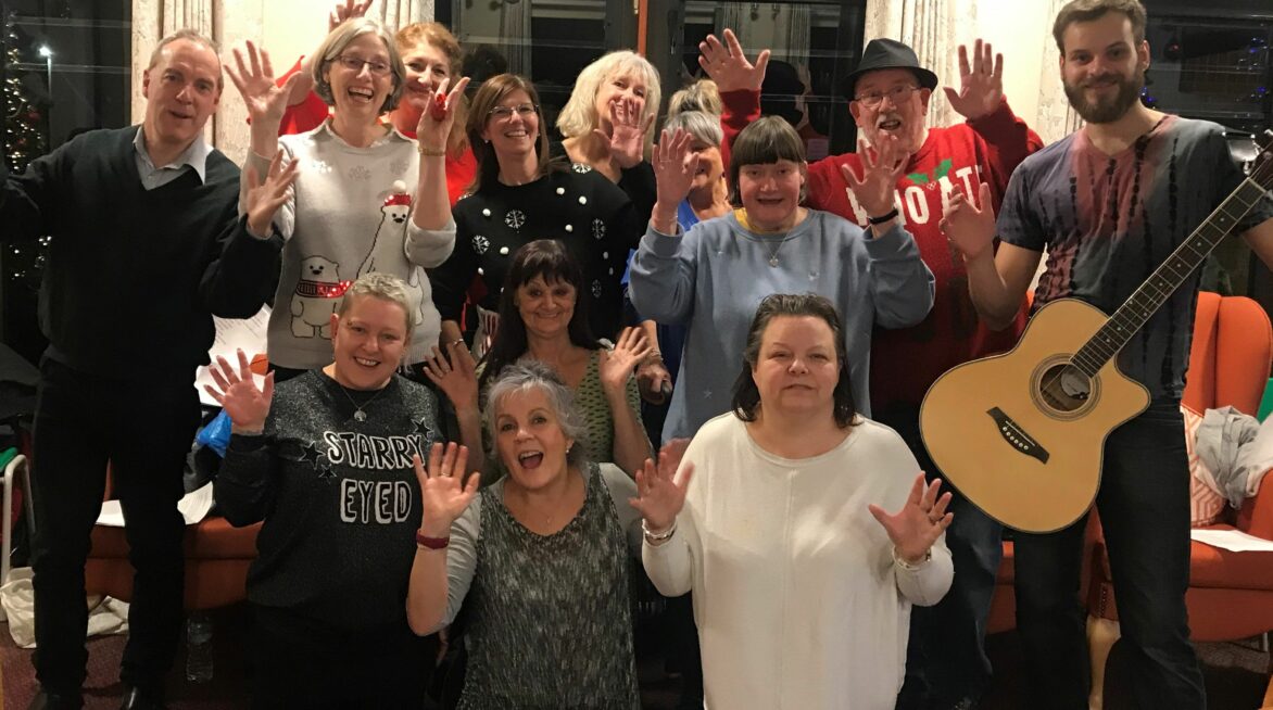 Friends in need group smiling at Christmas