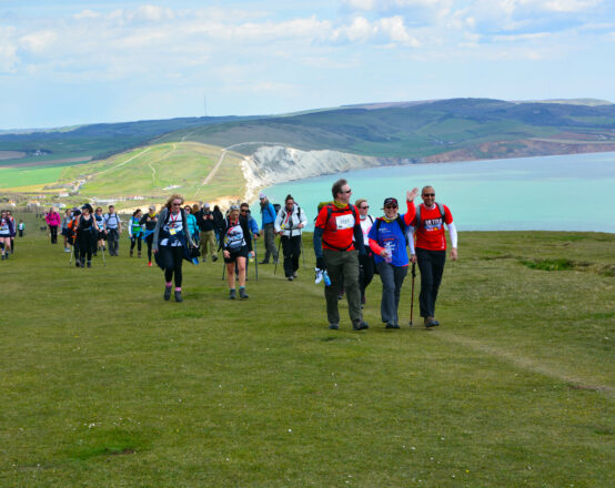 Hikers trekking along costal path