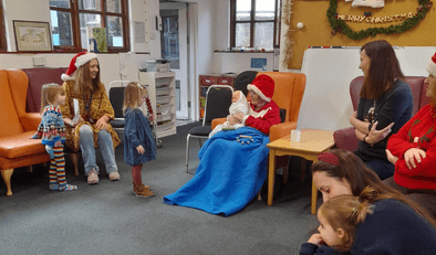 Child playing with older woman at Christmas