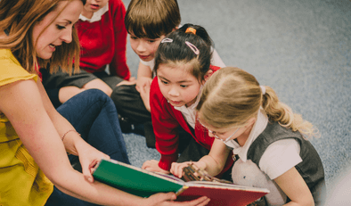 Teacher engaging children with book