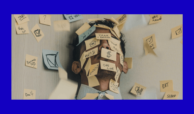 Overwhelmed man covered in post-it notes
