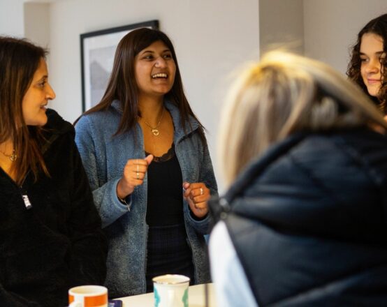 A group of young women talking and smiling