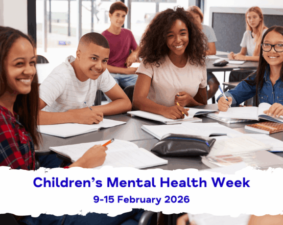 A diverse group of Secondary School age children, sitting around desks with pens and notepads. They're smiling and wearing non-uniform. The text reads: "Children's Mental Health Week, 9-15 February 2026."