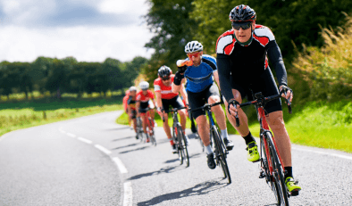 Cyclists in a race on a road in the countryside.
