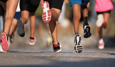 Lots of runners shown from behind from their knees downwards.