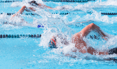 Lane swimmers in a swimming pool doing front crawl.
